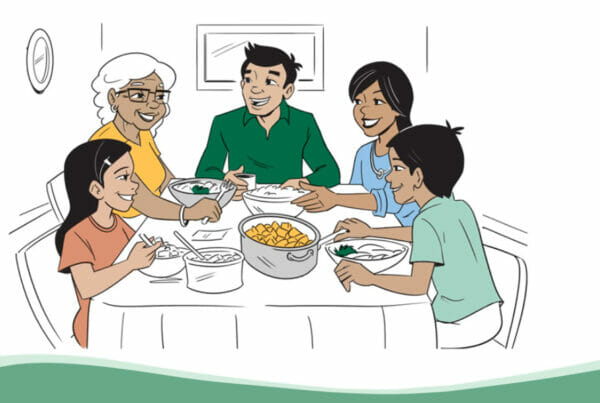 A still from Loaves & Fishes video; a family sits together at a table enjoying a meal together (whiteboard animation style)