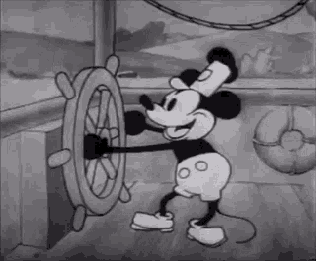 Steamboat Willie, a mickey mouse character, is animated in Black & White and is tapping his foot while driving a ship