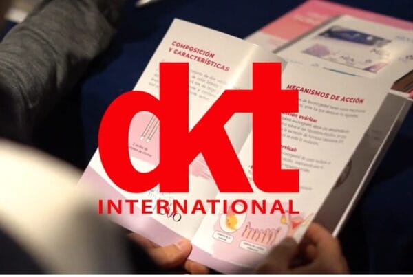 A still from DKT International's Live Action/Mixed Media explainer video; the DKT logo is superimposed over a live action shot of a pamphlet being read