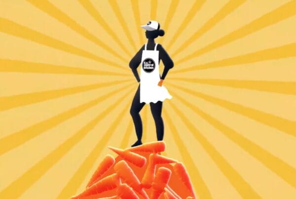 A screenshot from the 2D Animation created by Next Day Animations for the DC Central Kitchen. An animated character in volunteering outfit with DC Central Kitchen logo stands atop a mountain of carrots, triumphantly