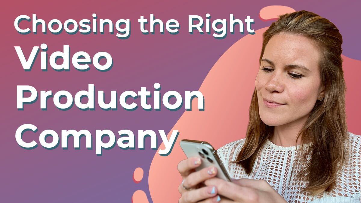 Title graphic reads "Choosing the Right Video production Company" in white serif font on a deep purple and salmon Next Day Animations background. Client advisor Cassandra poses next to the title, curiously examining her cell phone.